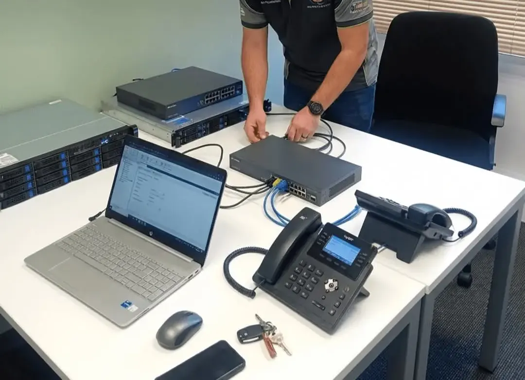 Ramscount engineer connecting ethernet cables to a network switch